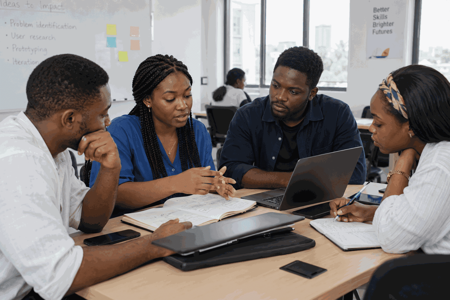 Graduates collaborating intently at a conference table